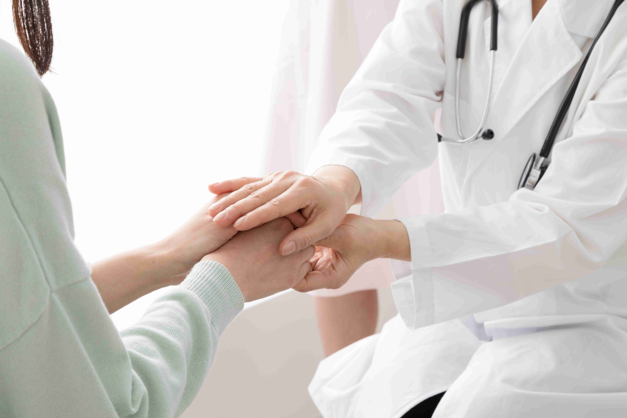 Hands providing a gentle acupuncture treatment